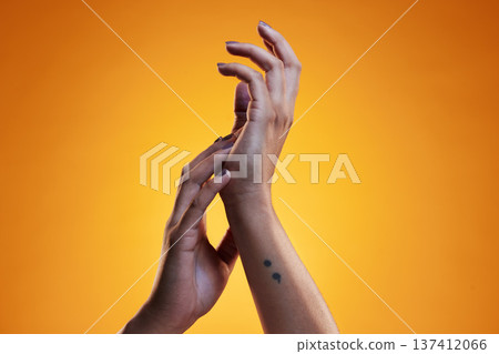 Hands, touch and skin care of a woman in studio with dermatology cosmetics and a manicure. Beauty salon, spa and a person on an orange background for wellness, health and clean body or hygiene 137412066