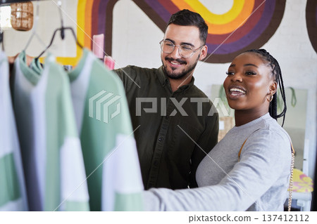 Retail, store and interracial couple shopping for fashion or style together in a mall and happy for clothes. Customer, man and woman on a date for bonding on vacation or holiday and purchase outfit Retail, store and interracial couple shopping for fashion or style together in a mall and happy for clothes. Customer, man and woman on a date for bonding on vacation or holiday and purchase outfit 137412112