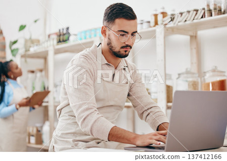 Man, small business and store for typing, laptop and notes with stock, supply chain and thinking with sustainable ideas. Entrepreneur, partnership and inventory checklist for product, woman and shop Man, small business and store for typing, laptop and notes with stock, supply chain and thinking with sustainable ideas. Entrepreneur, partnership and inventory checklist for product, woman and shop 137412166