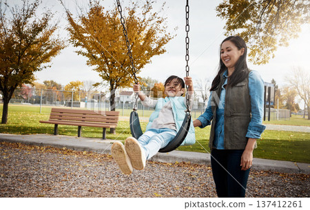 Asian family, smile or swinging with mother and daughter outdoor together for bonding or having fun. Afternoon, playful or weekend with happy girl child and single parent woman in park for break 137412261