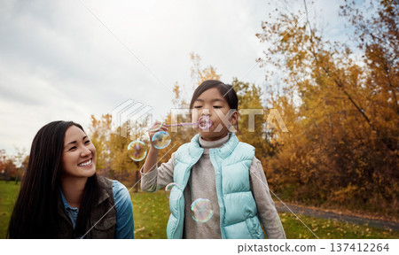 Smile, mom or daughter in park with bubbles, playful or bonding together in child growth. Fun, Asian woman or kid outdoor with blowing, healthy relationship or family connection in emotional security 137412264
