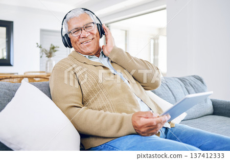 Portrait, home and old man with tablet, headphones and smile with connection, streaming music and radio. Senior person, technology and pensioner with headset, listening to audio and sound on a couch 137412333