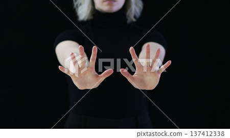 A gesture of open palms in front of you, which means calm down, I won't hurt you. A gesture of open palms in front of you, which means calm down, I won't hurt you. 137412338