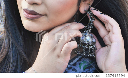 Bangladeshi young woman wearing traditional Jhumka earring, accentuating South Asian culture Bangladeshi young woman wearing traditional Jhumka earring, accentuating South Asian culture 137412394