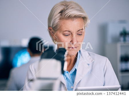 Science, tablet and medical with woman in laboratory for planning, research and pharmacy. Medicine, healthcare and digital report with mature scientist reading online for email, data and result 137412441