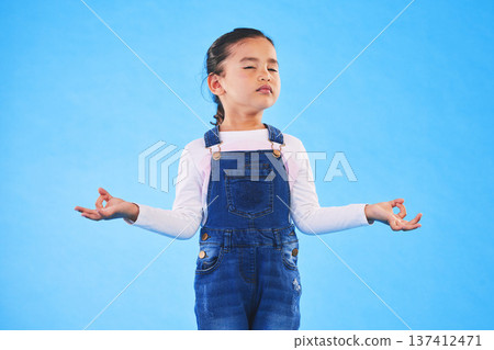 Girl child, zen and meditation in studio with eyes closed, peace and wellness by blue background. Female kid, mindfulness and balance chakra for health, breathing and development with yoga for energy Girl child, zen and meditation in studio with eyes closed, peace and wellness by blue background. Female kid, mindfulness and balance chakra for health, breathing and development with yoga for energy 137412471