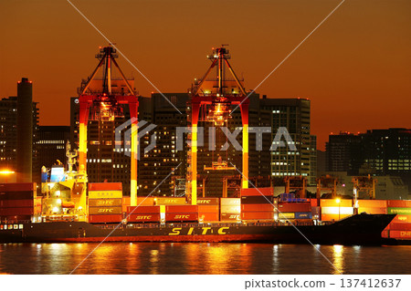 Large container ship loading containers at dusk (ship main) 137412637