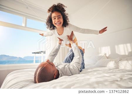Child, happy and parents on bed for airplane games, support and relax at home with crazy energy. Portrait of fun girl kid, dad and excited to fly in bedroom for freedom, fantasy and balance for play Child, happy and parents on bed for airplane games, support and relax at home with crazy energy. Portrait of fun girl kid, dad and excited to fly in bedroom for freedom, fantasy and balance for play 137412862