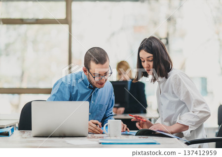 Colleagues working in office Colleagues working in office 137412959