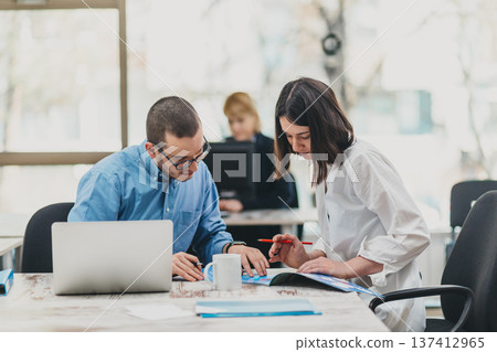 Colleagues working in office Colleagues working in office 137412965