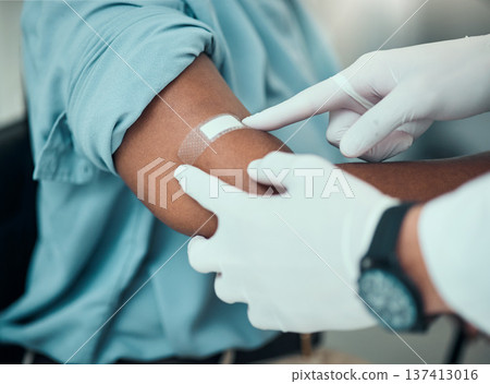 Plaster on arm, vaccine and wound, hands of doctor with patient and health, medicine and medical procedure. Bandage, injury and injection with people at hospital, healthcare and wellness with help 137413016
