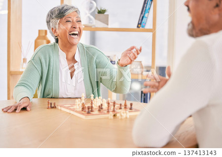 Laughing, game and senior couple with chess in a house in retirement for a competition. Happy, together and a funny and elderly man and woman with a board for a challenge or bonding with conversation Laughing, game and senior couple with chess in a house in retirement for a competition. Happy, together and a funny and elderly man and woman with a board for a challenge or bonding with conversation 137413143