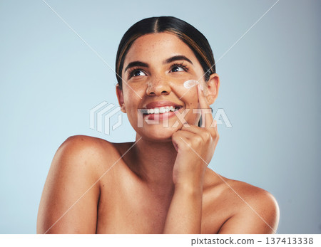Face, cosmetics cream and portrait of woman with aesthetic shine, dermatology and skincare makeup on studio background. Happy model thinking of facial sunscreen lotion for self care, beauty and glow 137413338