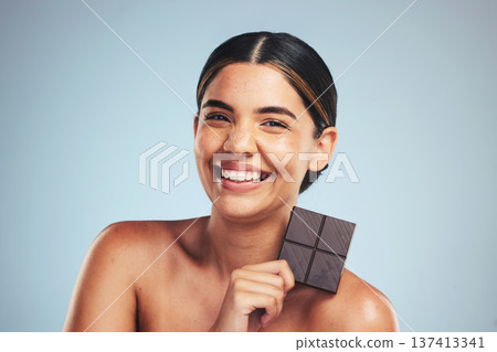 Portrait, chocolate and happy woman in studio with diet, craving or unhealthy luxury snack on grey background. Face, smile and lady model with candy bar, sugar and cocoa, addiction or diet temptation Portrait, chocolate and happy woman in studio with diet, craving or unhealthy luxury snack on grey background. Face, smile and lady model with candy bar, sugar and cocoa, addiction or diet temptation 137413341