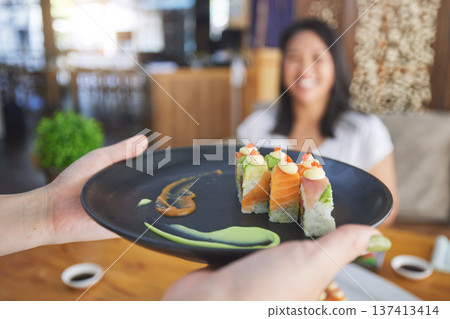 Sushi restaurant, people and waiter hands serving food plate, order or fish product for diner, cafeteria or shop customer. Startup small business, server and closeup person with lunch meal for client Sushi restaurant, people and waiter hands serving food plate, order or fish product for diner, cafeteria or shop customer. Startup small business, server and closeup person with lunch meal for client 137413414