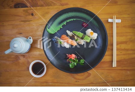Sushi, seafood and chopsticks in a chinese restaurant from above for fine dining or traditional cuisine. Salmon, menu and food with an asian dish on a table in a local eatery for hunger or nutrition Sushi, seafood and chopsticks in a chinese restaurant from above for fine dining or traditional cuisine. Salmon, menu and food with an asian dish on a table in a local eatery for hunger or nutrition 137413434