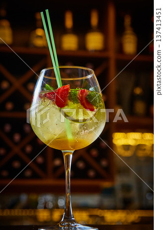 A multi-sensory cocktail featuring vibrant strawberries, lime, and mint in a chilled wine glass. A multi-sensory cocktail featuring vibrant strawberries, lime, and mint in a chilled wine glass. 137413451