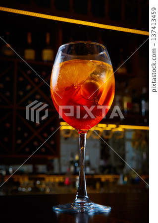 Aperol Spritz in a wine glass, featuring vibrant orange tones, tactile condensation 137413459