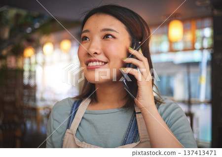 Restaurant, phone call and Asian woman for order, delivery and online food service in cafeteria. Coffee shop, small business and happy waitress, cafe barista or manager on smartphone in discussion Restaurant, phone call and Asian woman for order, delivery and online food service in cafeteria. Coffee shop, small business and happy waitress, cafe barista or manager on smartphone in discussion 137413471