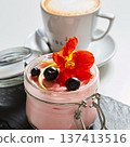 Luxury pink berry mousse served in an artisanal glass jar with fresh blueberries 137413516