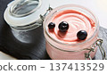 Luxury pink berry mousse served in an artisanal glass jar with fresh blueberries 137413529