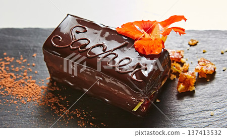 Vibrant sliced Sachertorte cake with rich chocolate ganache and apricot layers 137413532