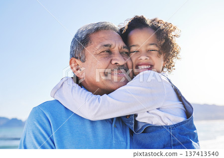 Grandfather, child and happy at the beach for vacation and travel together on outdoor holiday for happiness. Hug, smile and grandparent with kid or young grandchild by the ocean or sea for adventure Grandfather, child and happy at the beach for vacation and travel together on outdoor holiday for happiness. Hug, smile and grandparent with kid or young grandchild by the ocean or sea for adventure 137413540