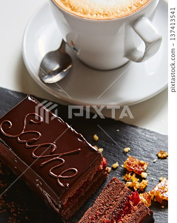 Vibrant sliced Sachertorte cake with rich chocolate ganache and apricot layers Vibrant sliced Sachertorte cake with rich chocolate ganache and apricot layers 137413541