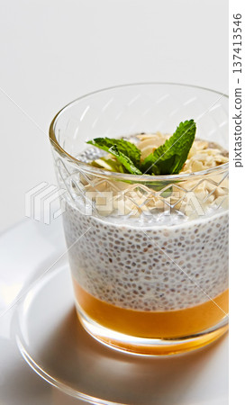 Artisanal breakfast parfait featuring layered chia seed pudding, mango puree Artisanal breakfast parfait featuring layered chia seed pudding, mango puree 137413546