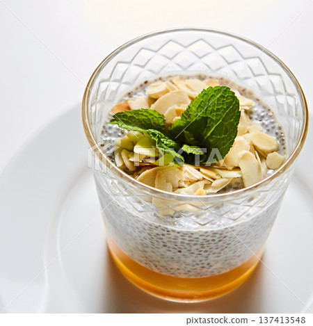 Artisanal breakfast parfait featuring layered chia seed pudding, mango puree Artisanal breakfast parfait featuring layered chia seed pudding, mango puree 137413548
