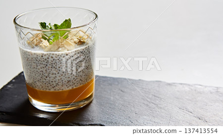 Artisanal breakfast parfait featuring layered chia seed pudding, mango puree Artisanal breakfast parfait featuring layered chia seed pudding, mango puree 137413554