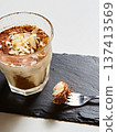 Artisanal tiramisu served in a modern glass with a heavy dusting of cocoa powder 137413569