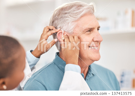 Helping, man and doctor with hearing aid, technology or healthcare or medical device consultation for deaf patient with tinnitus. Listening, test and exam ear tech with nurse or senior male in clinic Helping, man and doctor with hearing aid, technology or healthcare or medical device consultation for deaf patient with tinnitus. Listening, test and exam ear tech with nurse or senior male in clinic 137413575