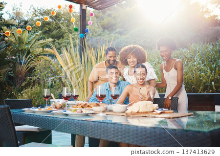 Selfie, group of friends at dinner in garden and happy event with diversity, food and wine at outdoor party. Photography, men and women at table, fun people with drinks in backyard at sunset together Selfie, group of friends at dinner in garden and happy event with diversity, food and wine at outdoor party. Photography, men and women at table, fun people with drinks in backyard at sunset together 137413629