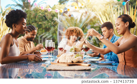 Friends at lunch, party in garden and happy event with diversity, food and wine for bonding together. Outdoor dinner, men and women at table, group of people eating with drinks in backyard in summer. 137413739