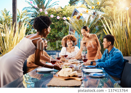 Friends, outdoor and eating food at a table for social gathering, happiness and holiday celebration. Diversity, men and women group at lunch, party or reunion with wine in a garden for fun and relax 137413764
