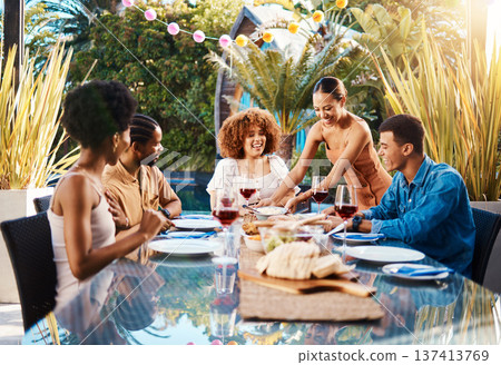 Friends, food and people outdoor at a table for social gathering, happiness and holiday celebration. Diversity, men and women group eating lunch at party or reunion with drinks to relax in a garden 137413769