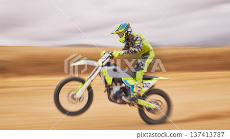 Fast, nature and a person on a motorbike for sports, travel or freedom in a race. Cycling, power and a man or professional driver with energy on a bike while driving for a challenge on a course Fast, nature and a person on a motorbike for sports, travel or freedom in a race. Cycling, power and a man or professional driver with energy on a bike while driving for a challenge on a course 137413787