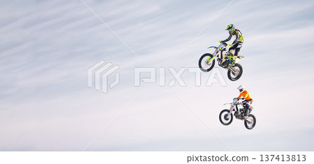 Sky, jump and men on motorbike together for practice, training and extreme sports energy in mockup. Professional dirt biking challenge, friends in air and danger with off road motorcycle competition. Sky, jump and men on motorbike together for practice, training and extreme sports energy in mockup. Professional dirt biking challenge, friends in air and danger with off road motorcycle competition. 137413813