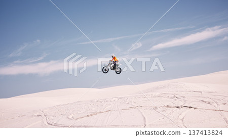 Bike, mockup and jump with a man in the desert riding a vehicle for adventure or adrenaline. Motorcycle, speed and training on sand with an athlete outdoor in nature for power or active competition Bike, mockup and jump with a man in the desert riding a vehicle for adventure or adrenaline. Motorcycle, speed and training on sand with an athlete outdoor in nature for power or active competition 137413824