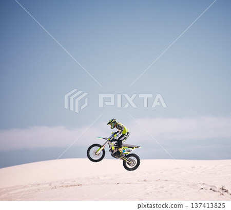 Bike, sky and jump with a man on mockup riding a vehicle in the desert for adventure or adrenaline. Motorcycle, speed and space with an athlete on sand in nature for freedom, power or competition Bike, sky and jump with a man on mockup riding a vehicle in the desert for adventure or adrenaline. Motorcycle, speed and space with an athlete on sand in nature for freedom, power or competition 137413825