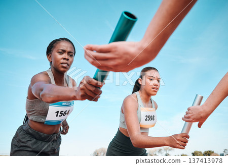 Woman, teamwork and baton in relay, running competition or sports fitness on stadium track. Active people or athlete passing bar in competitive race, sprint or coordination for team performance 137413978