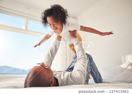 Child, happy and father on bed for airplane games, support and relax at home for crazy fun. Dad, kid and girl excited to fly in bedroom for freedom, fantasy and balance for play, care and energy Child, happy and father on bed for airplane games, support and relax at home for crazy fun. Dad, kid and girl excited to fly in bedroom for freedom, fantasy and balance for play, care and energy 137413981