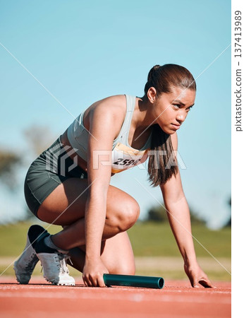 Start, running and relay with woman on race track with baton for sports, competition and marathon. Exercise, health and wellness with runner in stadium for challenge, speed and energy performance 137413989