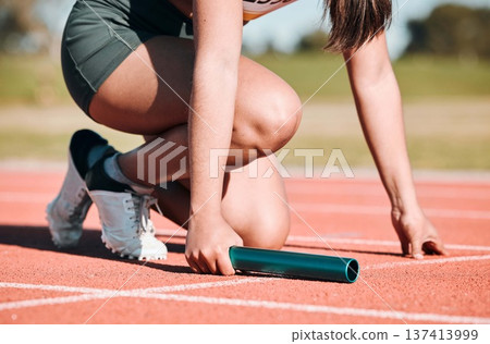Start, running and relay with hands of person on race track with baton for sports, competition and marathon. Exercise, health and wellness with closeup of runner in stadium for challenge and athlete Start, running and relay with hands of person on race track with baton for sports, competition and marathon. Exercise, health and wellness with closeup of runner in stadium for challenge and athlete 137413999