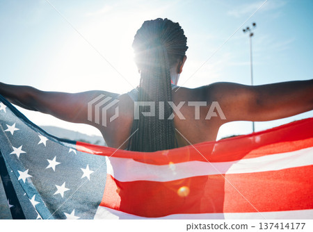Athlete, American flag and sports with a woman outdoor at a stadium to celebrate country, pride and win. Back of a person for sport event , fitness and exercise achievement at competition in USA 137414177