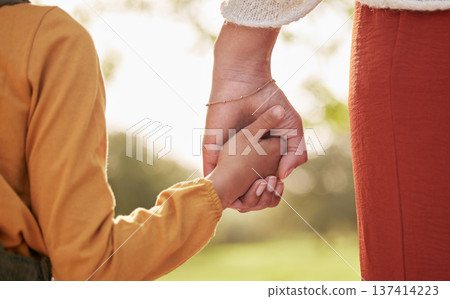 Mother, kid and holding hands for walking in park for support, trust and care together or bonding in nature. Love, comfort and parent help child in the morning sunshine with kindness on weekend 137414223