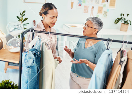 Consultant, fashion and shopping with client in shop for advice on fabric or products on promotion. Customer, retail sale or women talking in boutique mall for clothes deal, help or discount offer Consultant, fashion and shopping with client in shop for advice on fabric or products on promotion. Customer, retail sale or women talking in boutique mall for clothes deal, help or discount offer 137414334