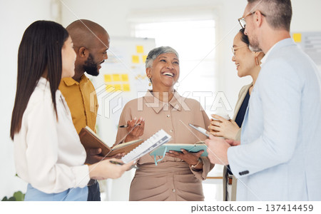 Tablet, collaboration and documents with a business team laughing in the office during a meeting. Technology, paper and funny with a manager talking to an employee group in a professional workplace Tablet, collaboration and documents with a business team laughing in the office during a meeting. Technology, paper and funny with a manager talking to an employee group in a professional workplace 137414459