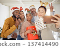 Business people, Christmas selfie and happy staff with present, peace sign or celebration for diversity at party. Men, women and photography for funny xmas memory, friends or gift for social network 137414490